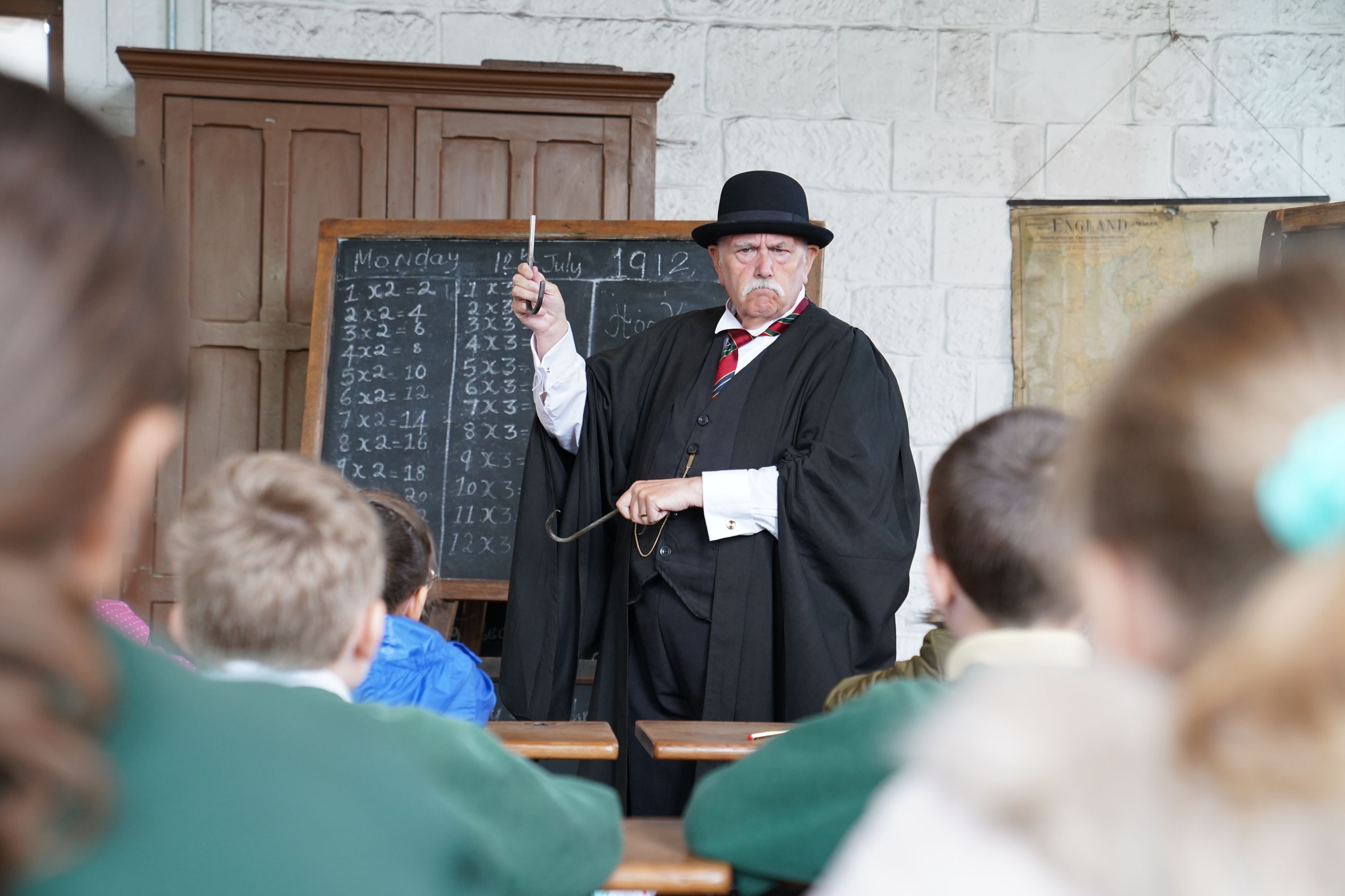 Key Stage 2 students experiencing and Edwardian School Teacher in class