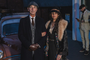 Peaky Blinders Nights visitors couple in costume car