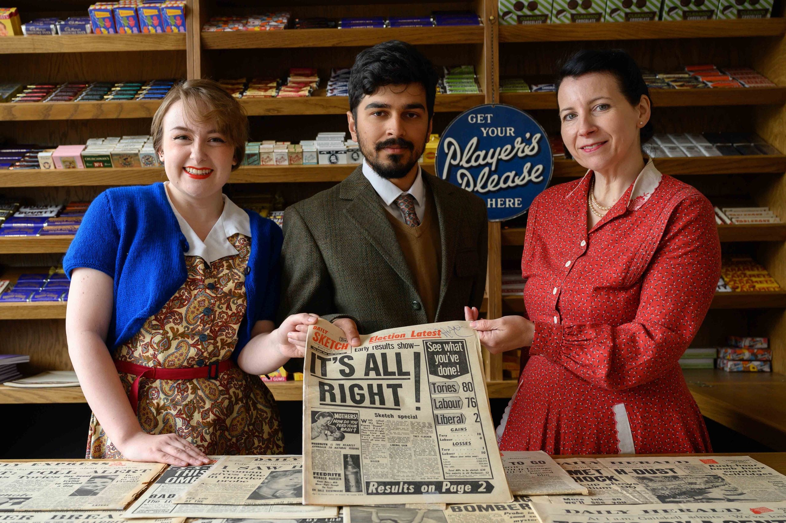 Group Photo Burgins Holding Newspaper