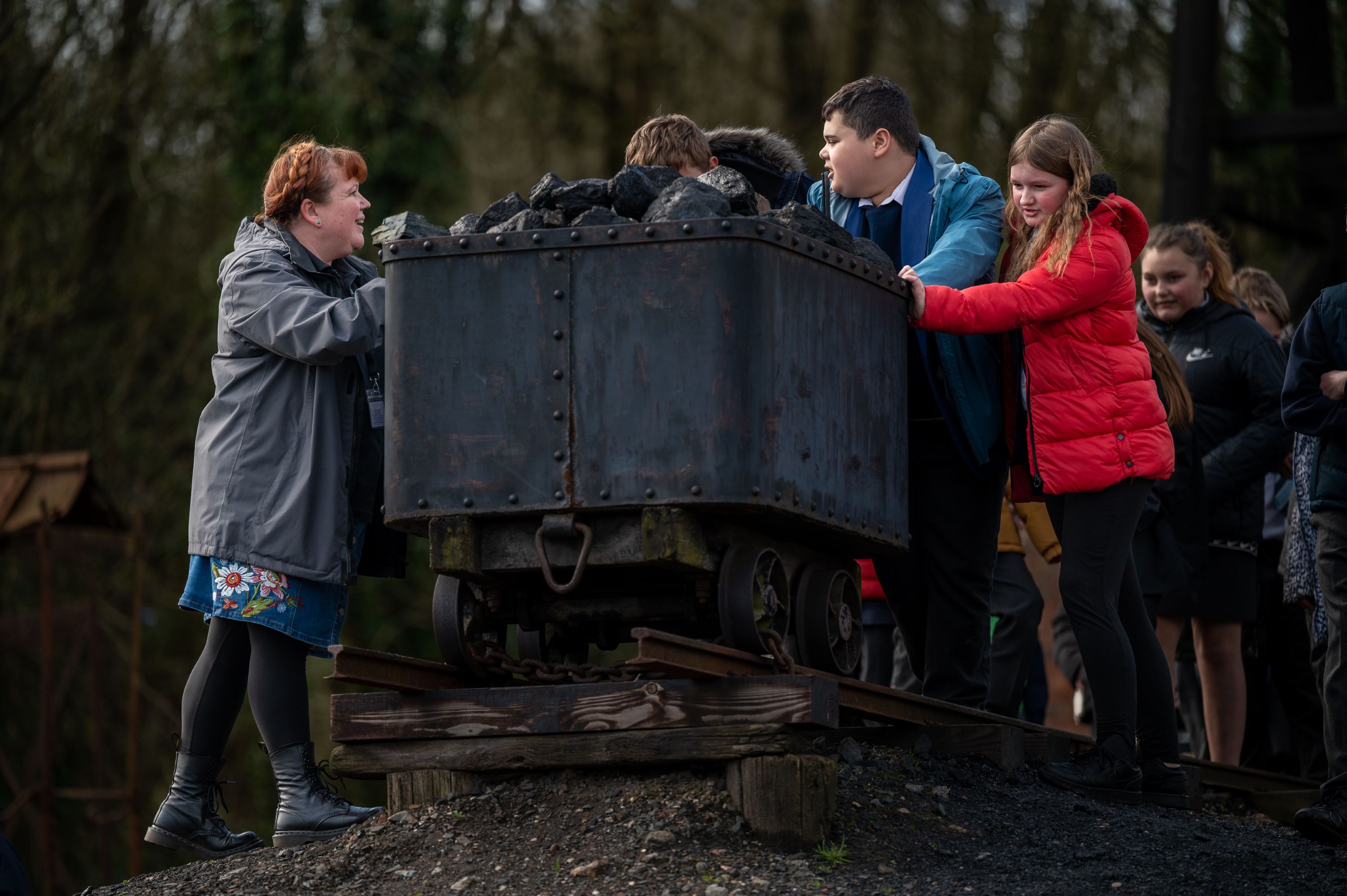 Key Stage 2 students pushing the colliery coal truck 