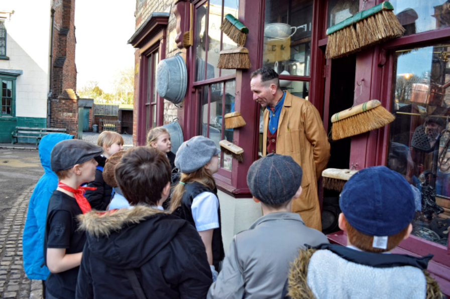 Key Stage 2 School Children on a visit talking to the Langstons Hardware  Store Shopkeeper