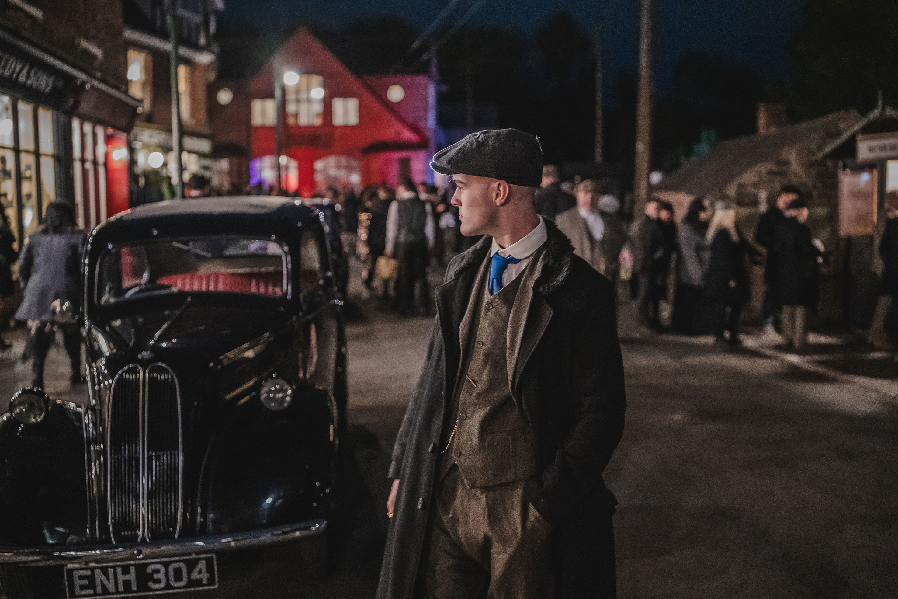 Peaky Blinders Nights young man standing next to car 1930s street
