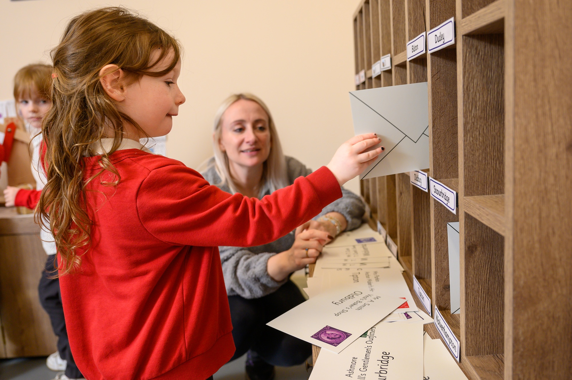 Early Years Children enjoying the 1950s sorting office for post