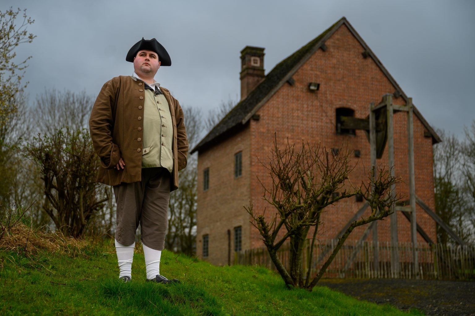 Historic Character Thomas Newcomen stood outside the Newcomen Steam engine house